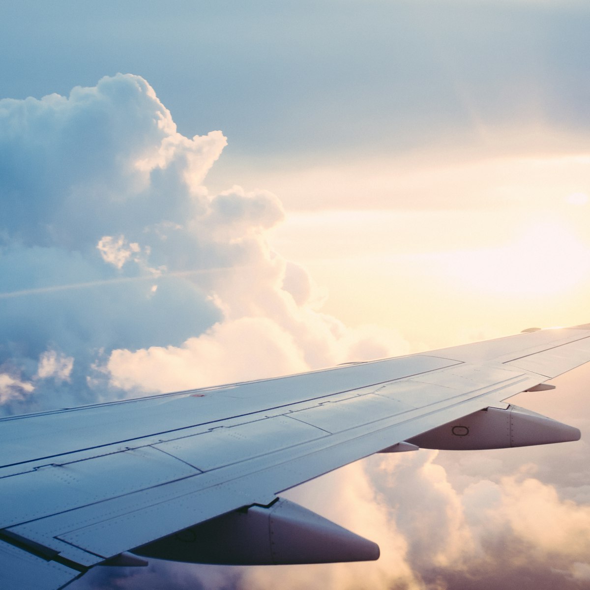 Ala de un avión de carga sobre las nubes al atardecer